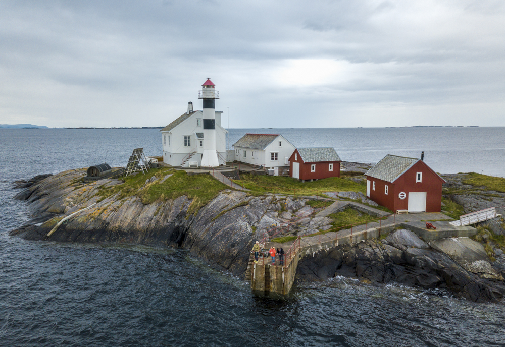 Luftfoto av Flatflesa Fyr omgitt av sjø og svaberg.